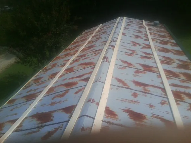 Rusted metal roof panels with new wood purlins before replacement — Storm Damage Roof Repair in Intervale by Roofing Brothers