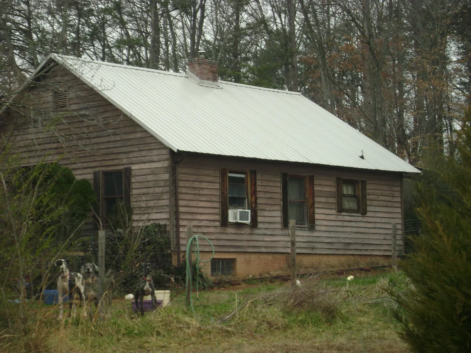 White metal roof on an old wood sided farmhouse, from a Metal Roof Installation job in Intervale